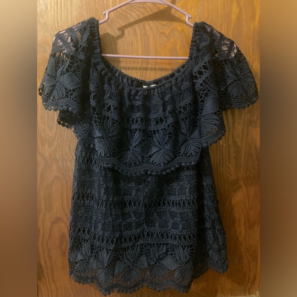 Navy blue lacy off-the-shoulder blouse.